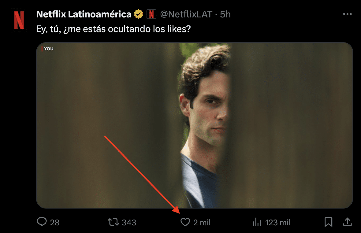 captura de pantalla de publicación en X (Twitter) con una flecha que apunta al botón Me gusta